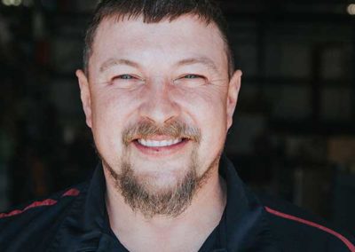 Matt Keatts - Short dark hair with blue eyes a mustache and goatee.