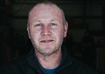 Rob Cripps - Short graying hair and beard. Blue eyes nice smile.