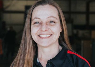 Tabatha King - Long light brown hair and brows. Blue eyes with nice smile and white teeth. Wearing Ashbusters collar shirt.