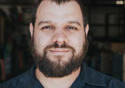 Joe Grey - Dark short hair eyebrows mustache and longish beard. He has brown eyes and a nice smile.