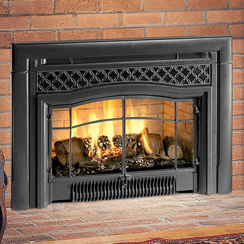 fire burning inside black fireplace insert with brown brick hearth
