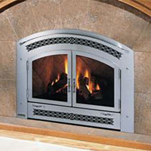 Metal silver arched fireplace insert with fire burning in it