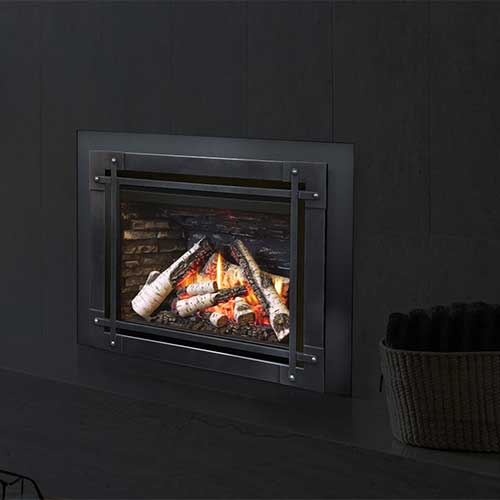 black fireplace insert with white birch firewood burning inside it
