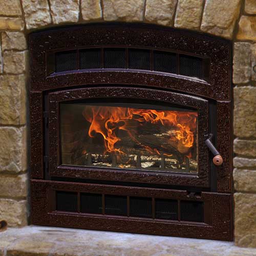 Arched shaped brownish red fireplace insert with large bricks on the hearth and fireplace burning in it